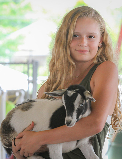 Girl holding a goat