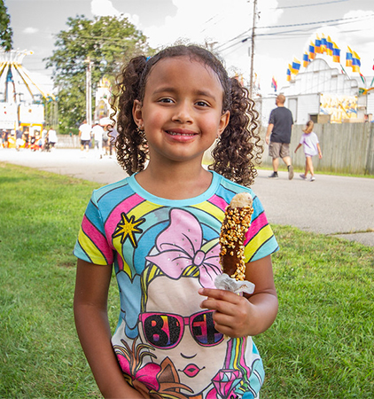 A girl eating a frozen banana