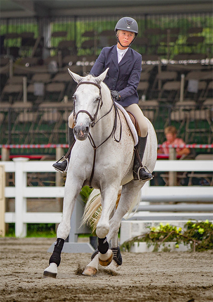 Girl riding her horse