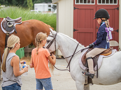 Two girls petting a horse