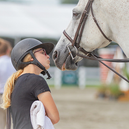 A girl kissing her horse